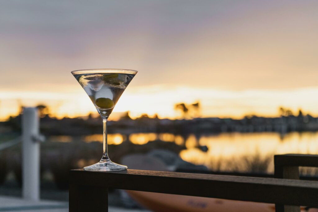 martini cocktail served with beautiful view in the background