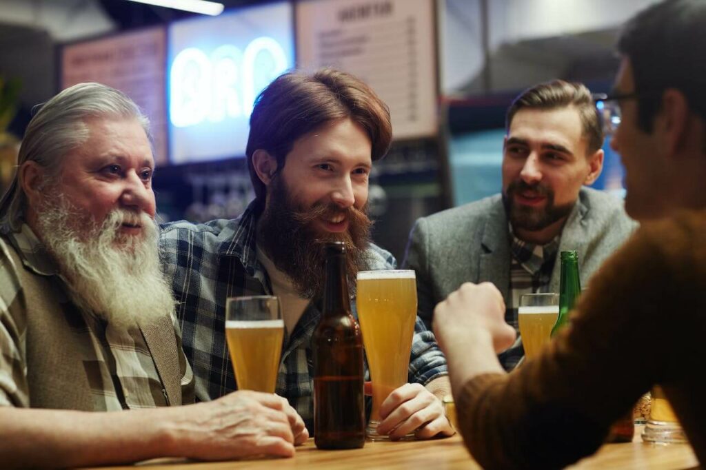 bartender speaking to three men customers