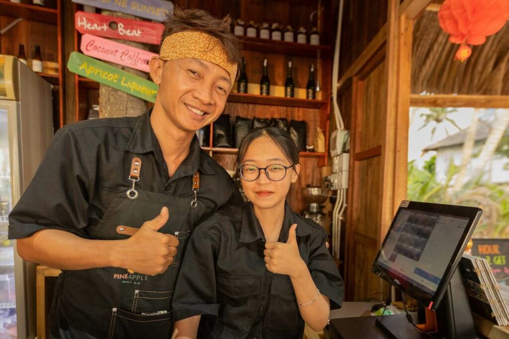 man and woman bartenders smiling with thumbs up